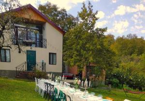 a table set up in front of a house at Cottage in Racha Mero in Nikortsminda