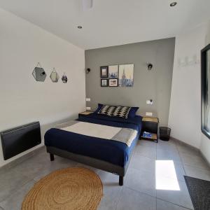 a bedroom with a bed and a flat screen tv at Mas les jasses Chambre d'hôte calme et agréable à la campagne in Ferrières-les-Verreries