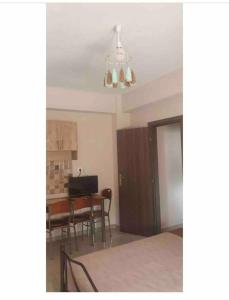 a room with a dining room table and a chandelier at Margaret home 