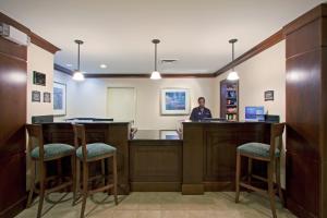a man standing at a bar in a waiting room at Staybridge Suites Fort Wayne, an IHG Hotel in Fort Wayne