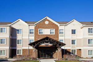 a large brick building with an arch entrance at Staybridge Suites Fort Wayne, an IHG Hotel in Fort Wayne