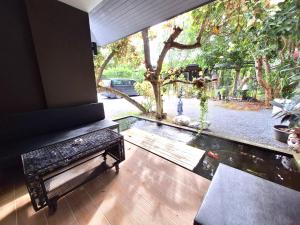 a room with a view of a garden with a bench at Seava House Ao-Nang Krabi in Ao Nang Beach
