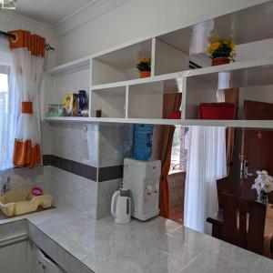 a kitchen with white shelves and a small refrigerator at Westlands bliss haven paradise fully furnished 1bedroom apartments 