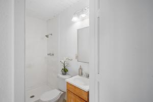 a white bathroom with a toilet and a sink at Milpitas Homestay Room in Milpitas