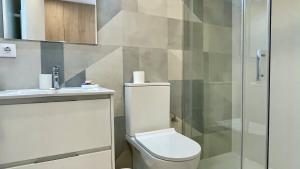 a bathroom with a toilet and a glass shower at Ribalta 1-1 in L'Escala +15 photos