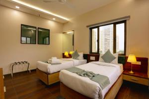 Postel nebo postele na pokoji v ubytování Hotel Ozone Inn Colaba