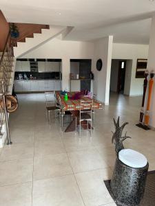 a kitchen and dining room with a table and chairs at Villa entiere avec piscine in Darou Rhamane