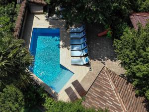 an overhead view of a swimming pool with lounge chairs at Villa Amalia Apartments in Malinska