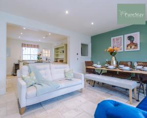 a living room with a white couch and a table at Huge Four Bedroom Townhouse By PureStay Short Lets & Serviced Accommodation Bath in Bath