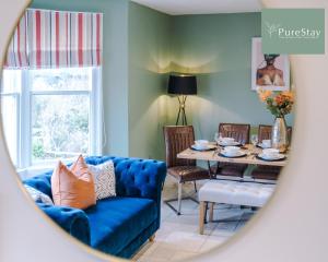 a living room with a blue couch and a table at Huge Four Bedroom Townhouse By PureStay Short Lets & Serviced Accommodation Bath in Bath