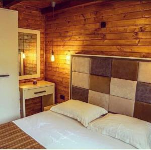 a bedroom with a bed and a wooden wall at Speakeasy 1 - 2 in Sveti Nikola