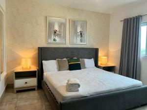 a bedroom with a large bed with two night stands at SOHA SUITES II in Santiago de los Caballeros +191 photos