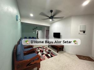 a living room with a ceiling fan and blue chairs at Dhome Bayu Alor Setar in Alor Setar