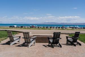 three chairs and a table and a bench and the beach at Sun Outdoors Garden City Utah in Garden City