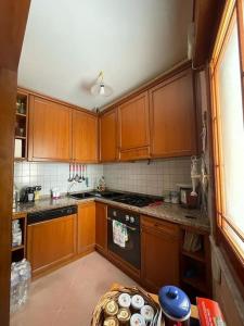 a kitchen with wooden cabinets and a stove top oven at La casa nel cortile in Castelbuono
