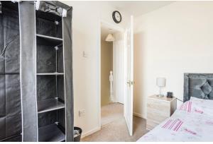 a bedroom with a black bookcase next to a bed at Lovely private room 