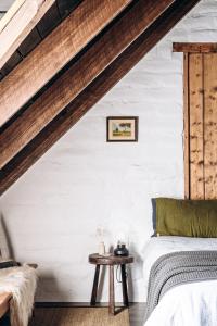 a bedroom with a bed and a table at The Stable Lofts in Carrick