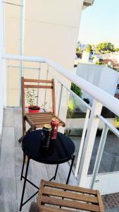 a small table and a chair on a balcony at SoHo Flat in Tandil