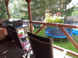 uma varanda com um grelhador e uma mesa com um trampolim em Ferienwohnung zum Sebnitzer Hirsch em Sebnitz