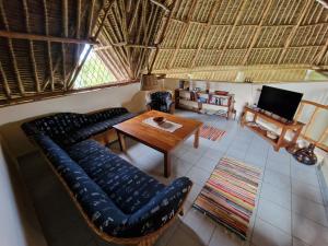 een woonkamer met een bank en een tafel bij Paradiesische Villa Maisha Mazuri mit Pool. Terrasse und Personal in Diani Beach