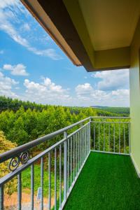 a balcony with a view of the woods at MANDJ STAYS in Seeta
