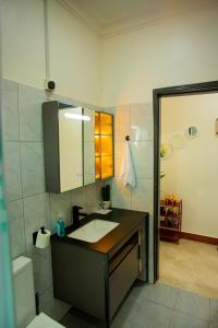 a bathroom with a sink and a mirror at MANDJ STAYS in Seeta