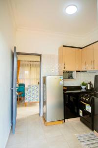 a kitchen with a stainless steel refrigerator in it at MANDJ STAYS in Seeta