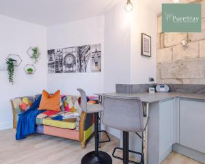 a room with a couch and a table and a desk at Incredible Five Bedroom House By PureStay Short Lets & Serviced Accommodation Central Bath With Parking in Bath