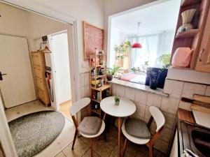 a small kitchen with a table and chairs in a room at INNY Apartament Rynek Opole in Opole