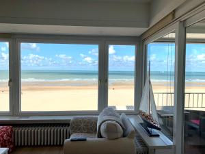 a living room with a view of the beach at Residentie Rapallo Oostende with fantastic Sea View! in Ostend