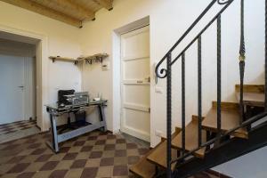 a room with a staircase and a table with a desk at B&B del Massimo in Palermo