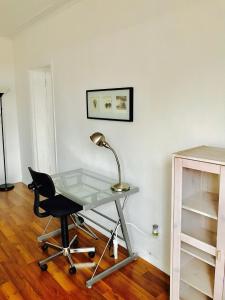 a glass desk with a lamp and a chair at Stylish Montreal Apartment: Comfortable Stay in the Golden Square Mile in Montreal