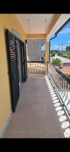 a balcony with a swing on a house at Casa De Ferias Santos in Aguiar da Beira