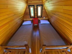 Ένα ή περισσότερα κρεβάτια σε δωμάτιο στο Pousada Sítio Elias - Chalé 2