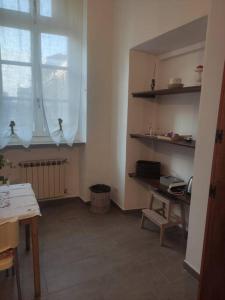 a kitchen with a table and a window and a desk at spazio q16 Quadrilatero Torino in Turin