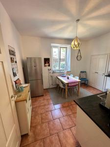 a kitchen with a table and a dining room at Villa Anton in Murnau am Staffelsee