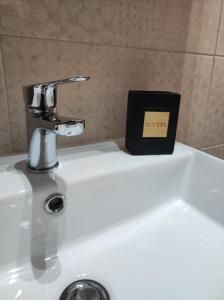 a bathroom sink with a faucet and a black box on it at Civico 185 in Acri