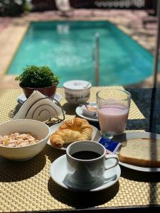 una mesa con desayuno y una taza de café en Ox Hotel en Puerto Iguazú
