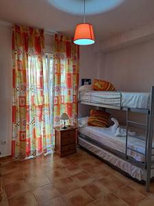 a room with two bunk beds and a lamp at Apartamento San Jose in San José