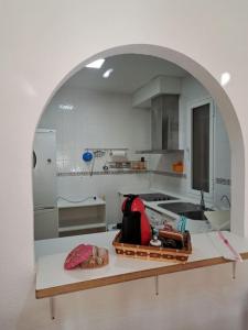 a kitchen with an archway in a white kitchen at Apartamento San Jose in San José +14 photos