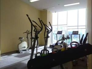 a gym with several cardio bikes in a room at Comfy Casa in Jakarta