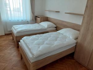 two twin beds in a room with at Penzion ČESKÁ FARMA in Vysoké Mýto