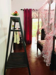 a ladder in a room with a bed and a window at Peacock Villa Resort in Udawalawe