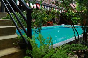 a swimming pool in a garden with plants at Negombo The Nature Villa and Cabanas in Negombo