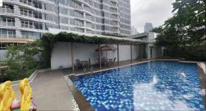 a large swimming pool in the middle of a building at Comfy Casa in Jakarta