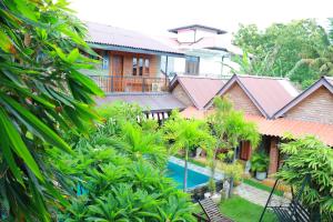 an image of a house with a swimming pool and trees at Negombo The Nature Villa and Cabanas in Negombo