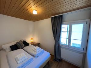a bedroom with a bed with a window and a bed sidx sidx sidx at Gasthaus Tell in Andermatt