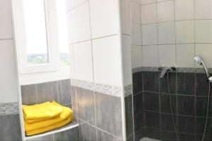 a bathroom with a shower with a yellow towel at Manoir - Studio - Fibre-wifi - Avon in Avon