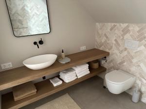 a bathroom with a white sink and a toilet at Luxe Loft in Historisch Pand in Walstraat Deventer in Deventer