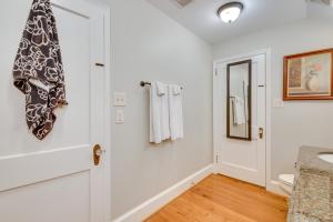 a bathroom with white walls and a door at Welcoming Norcross Cottage with Deck and Shared Grill! in Norcross